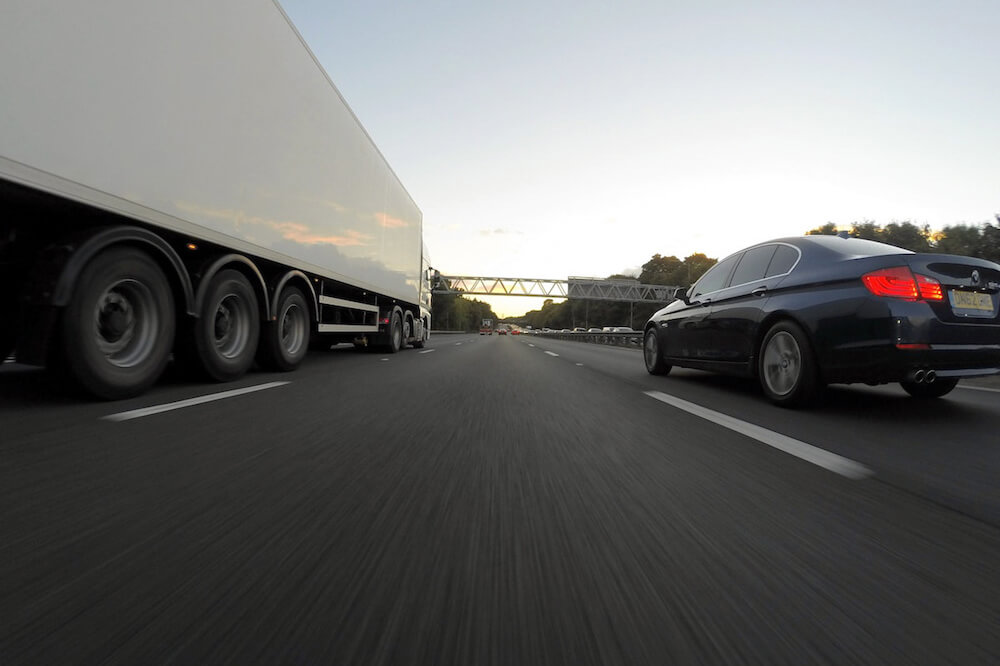 truck and car on highway