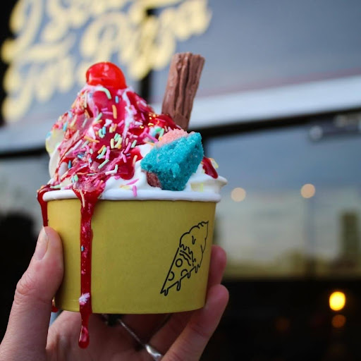 Custom printed ice cream cup with vibrant toppings and drizzle.